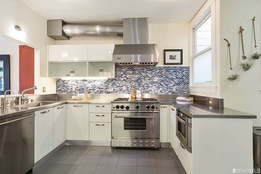 Property Photo: Kitchen, featuring white cabinets 