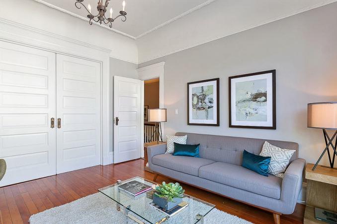Property Thumbnail: View of the living room, featuring crown moulding and wood floors