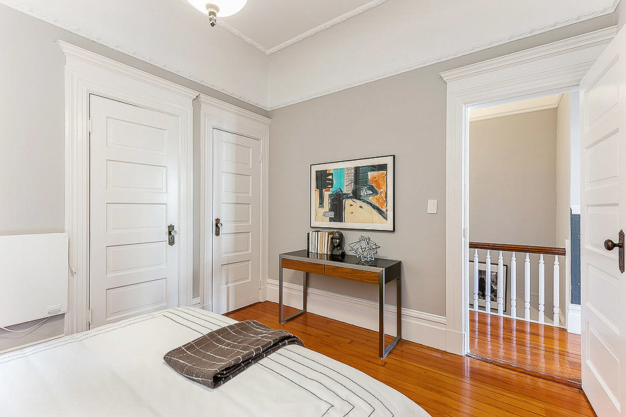 Property Photo: View of a bedroom with wood floors and crown moulding 