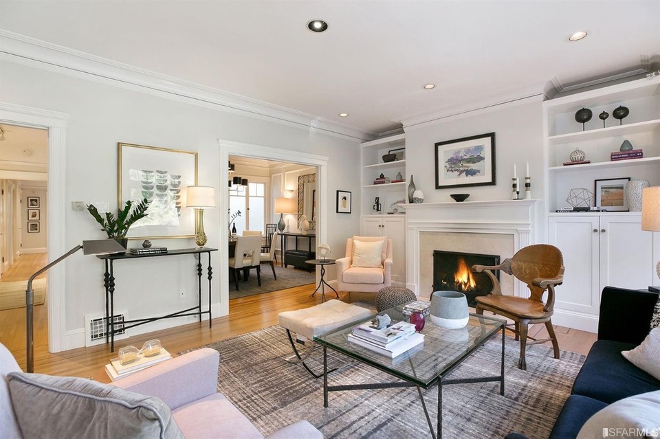 Property Photo: View of the living room, featuring a fireplace and wood floors