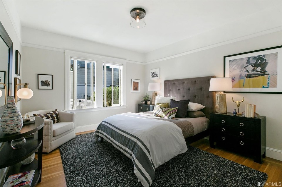 Property Photo: View of a large bedroom with big windows and wood floor