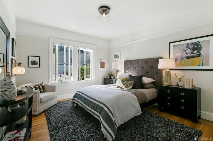 Property Thumbnail: View of a large bedroom with big windows and wood floor