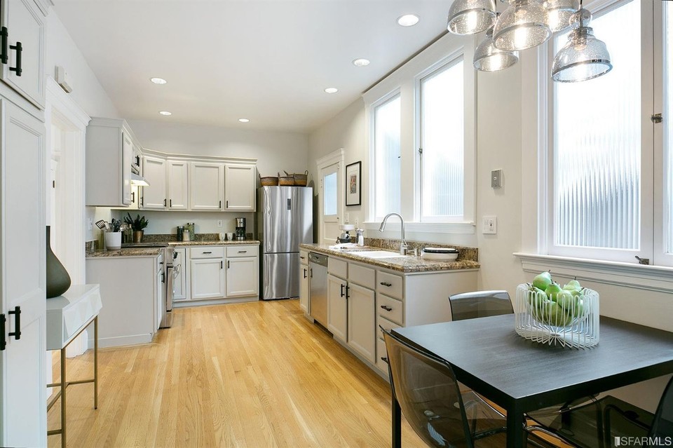 Property Photo: View of the kitchen, featuring light-colored cabinets