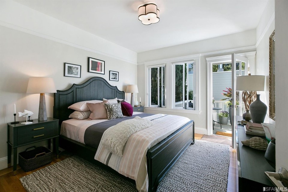 Property Photo: Large bedroom with windows and exterior door