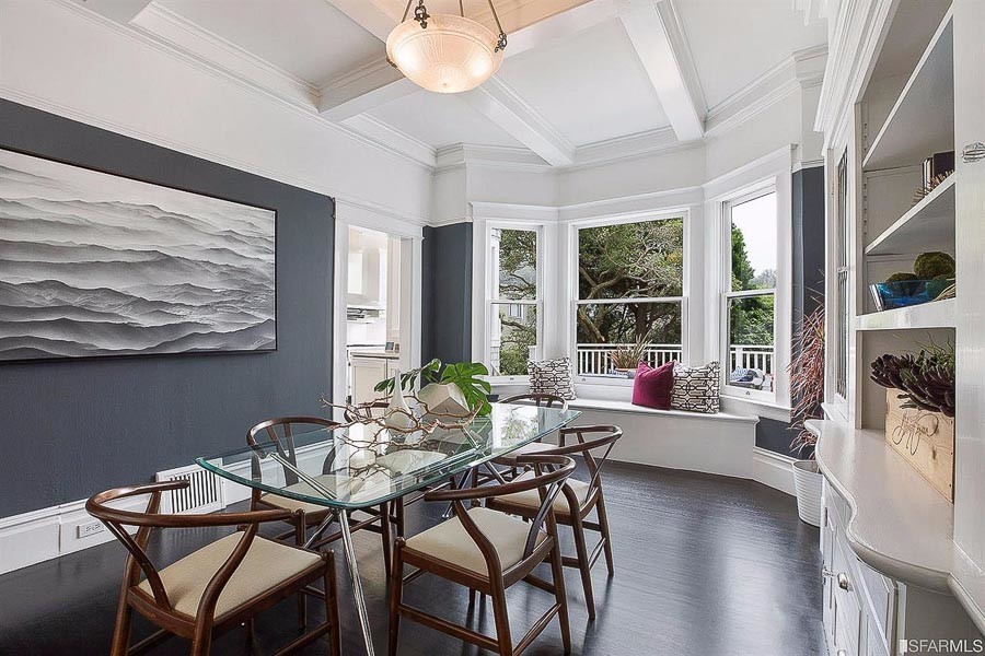 Property Photo: Dining room with wood floors and large bay windows