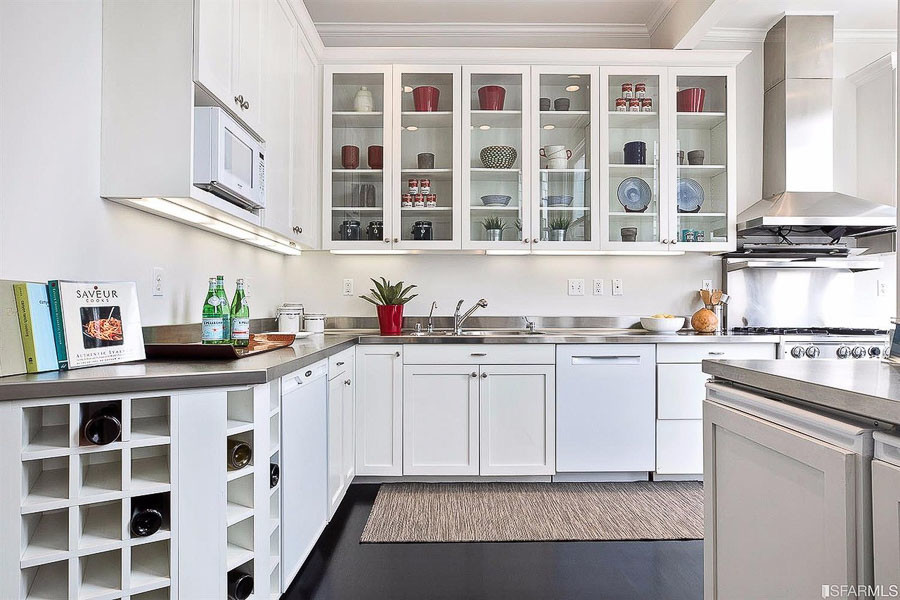 Property Photo: View of the kitchen featuring white cabinets