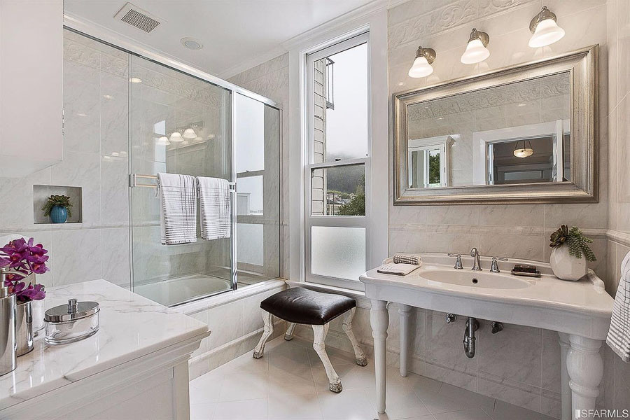 Property Photo: View of a bathroom with large sink and glass-front shower