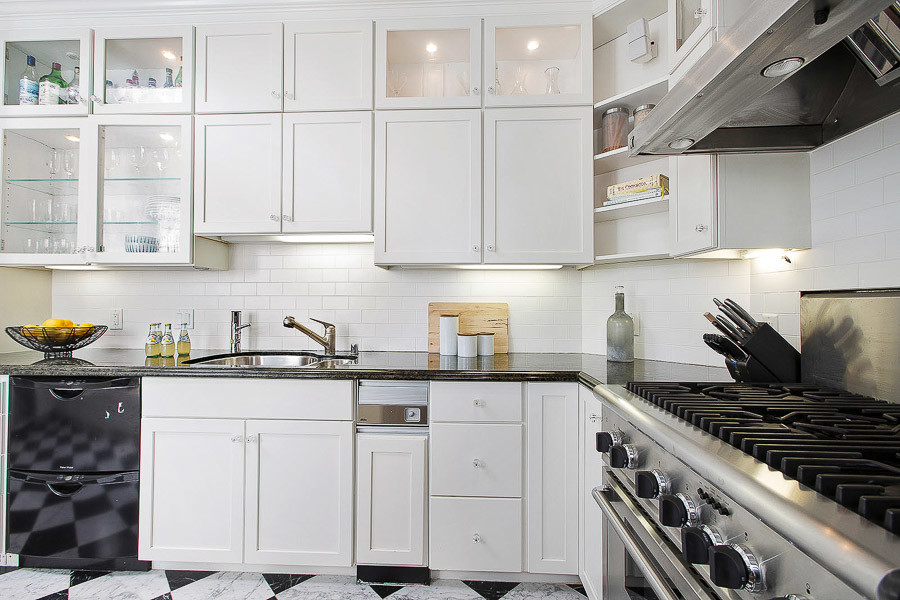 Property Photo: Close-up view of the white kitchen cabinets