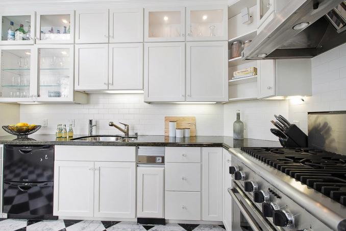 Property Thumbnail: Close-up view of the white kitchen cabinets