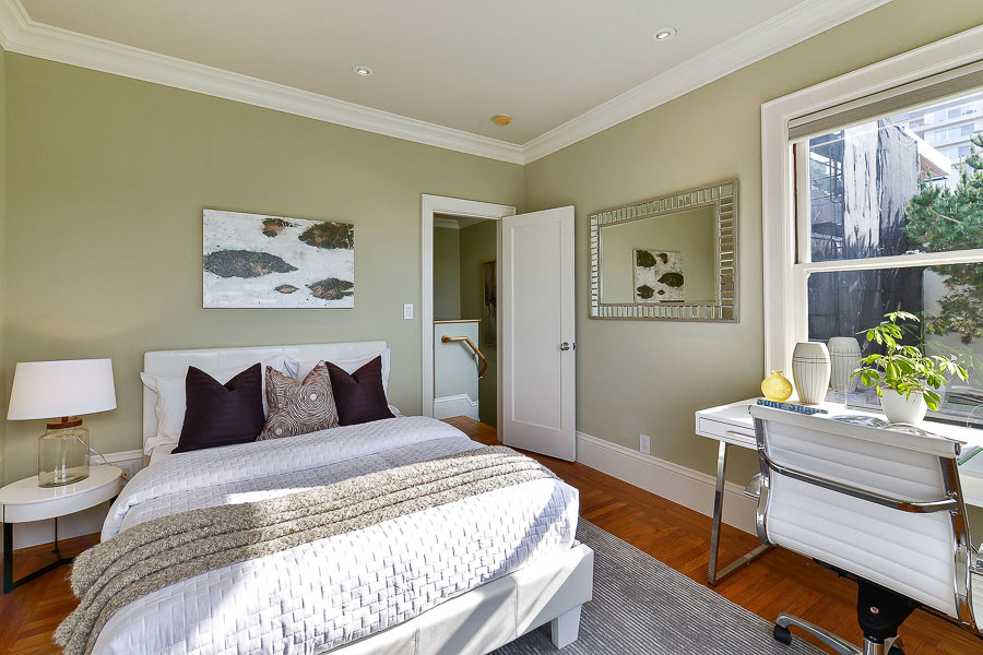 Property Photo: Bedroom with wood floors and crown moulding 