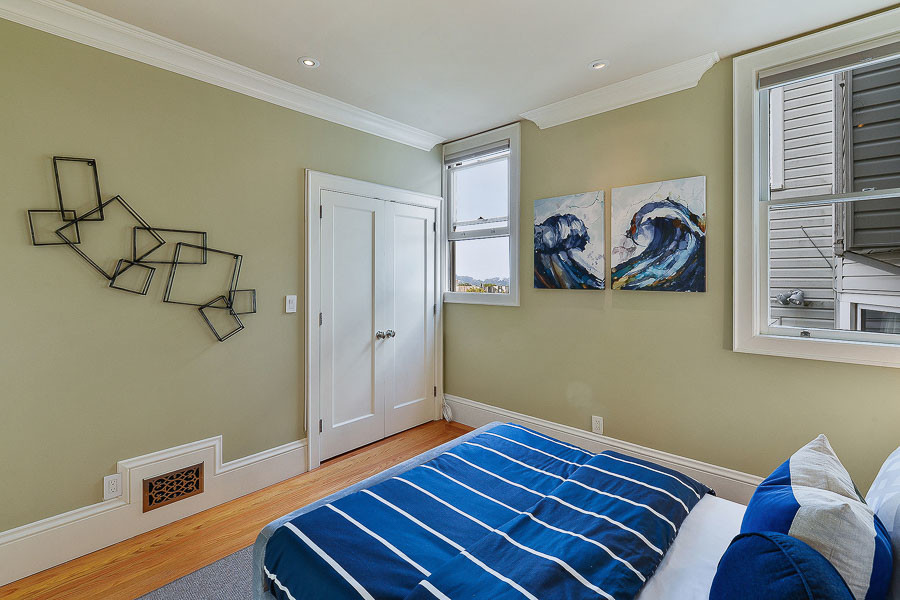 Property Photo: View of another bedroom with two windows and wood floors