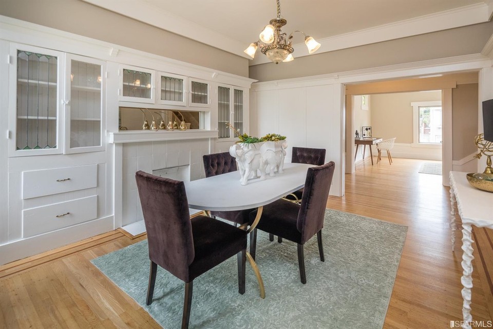Property Photo: View of the formal dining room featuring wood floors and large fireplace mantle