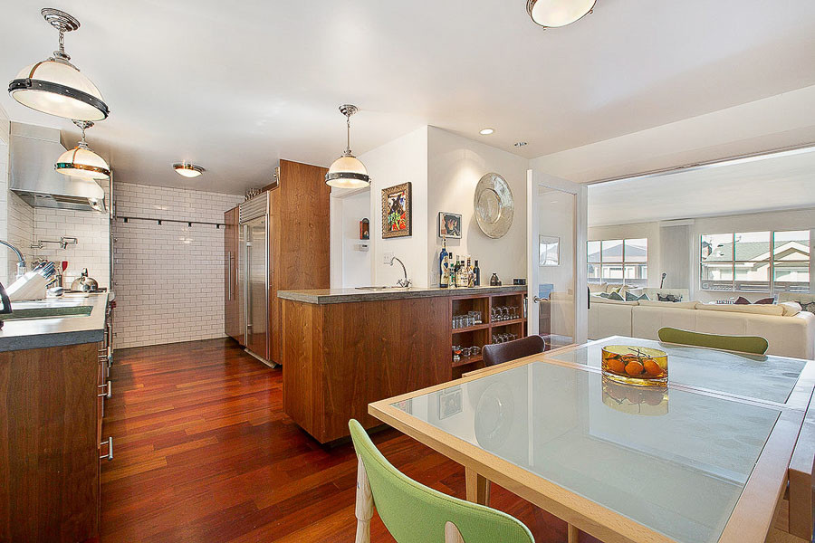 Property Photo: View of the eat-in kitchen space, featuring wood floors