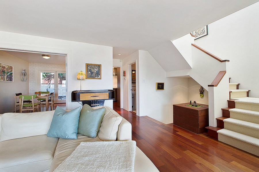 Property Photo: Partial view of a stairway and living area