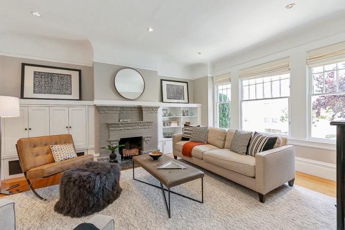 Property Thumbnail: View of the living room, featuring large windows and a fireplace