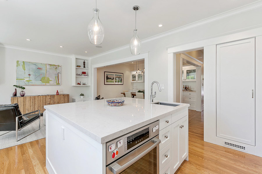 Property Photo: View of the kitchen featuring a white island cabinet with sink