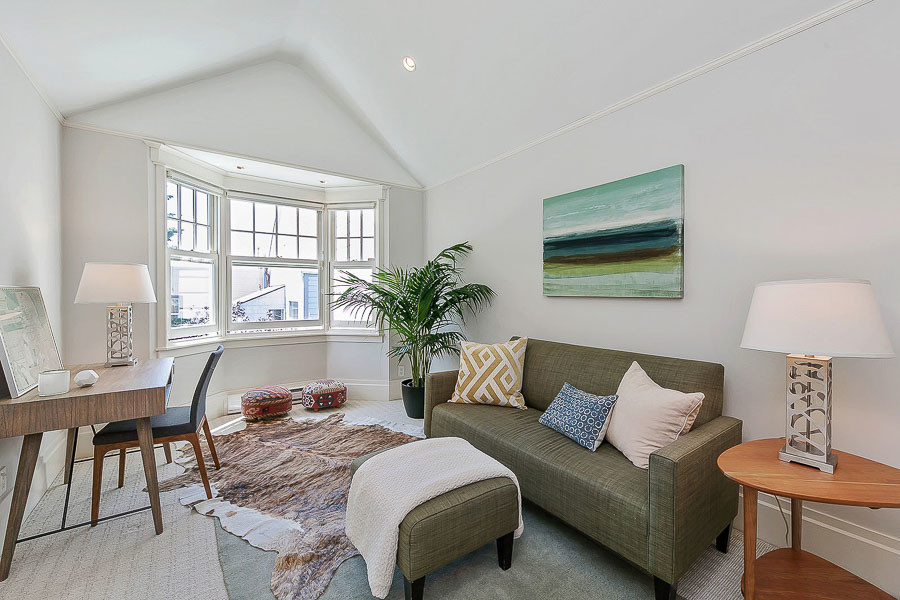 Property Photo: View of a room with bay windows and carpeted flooring 