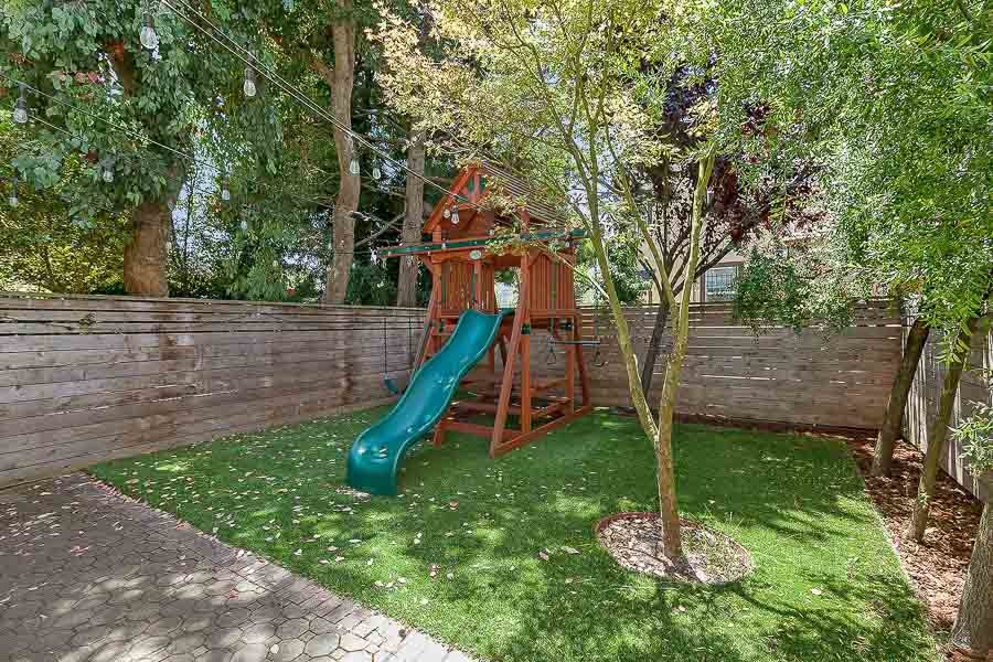Property Photo: View of the back yard, featuring a grassy area and trees 