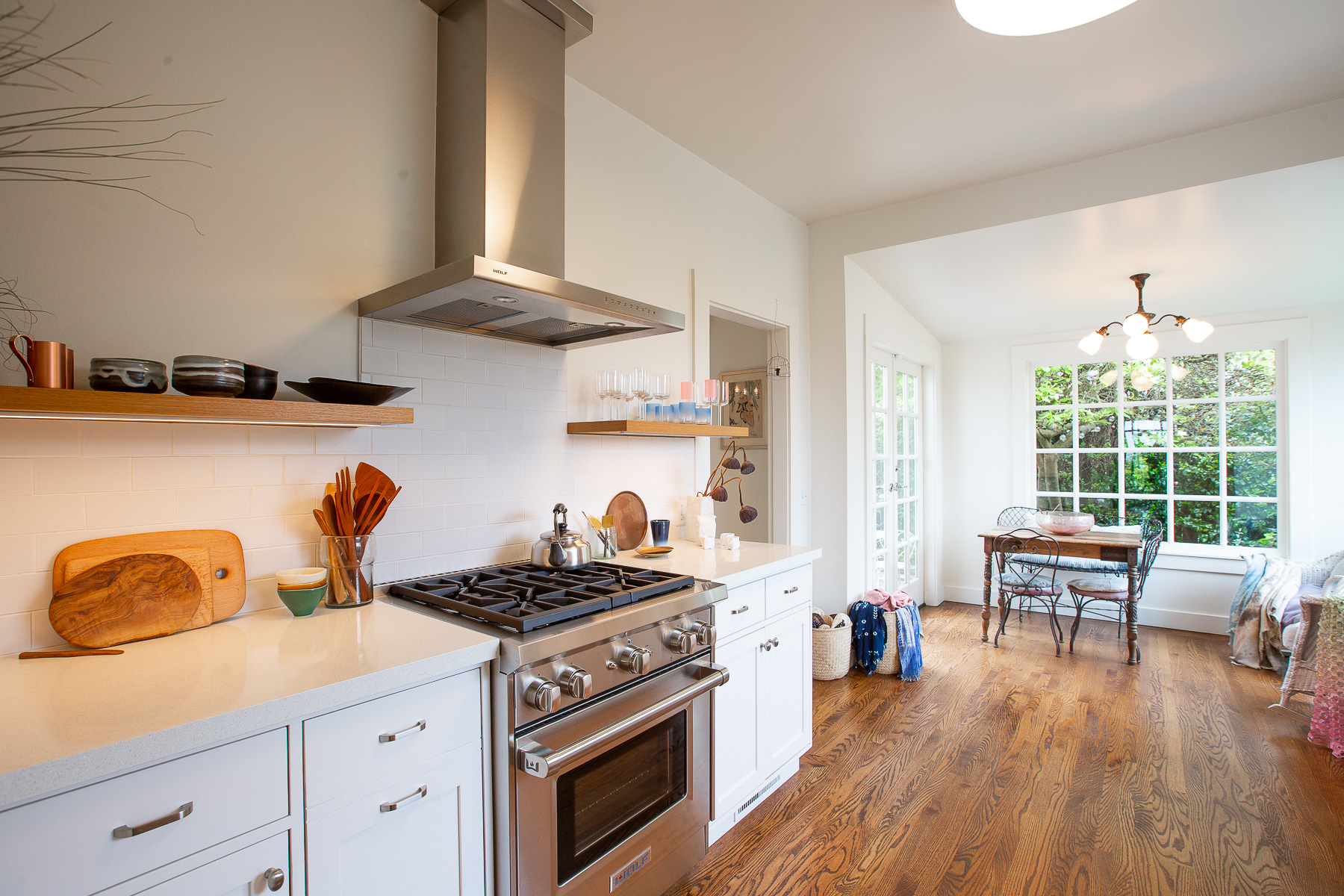 Property Photo: View of the stainless stove and adjoining eat-in sunroom