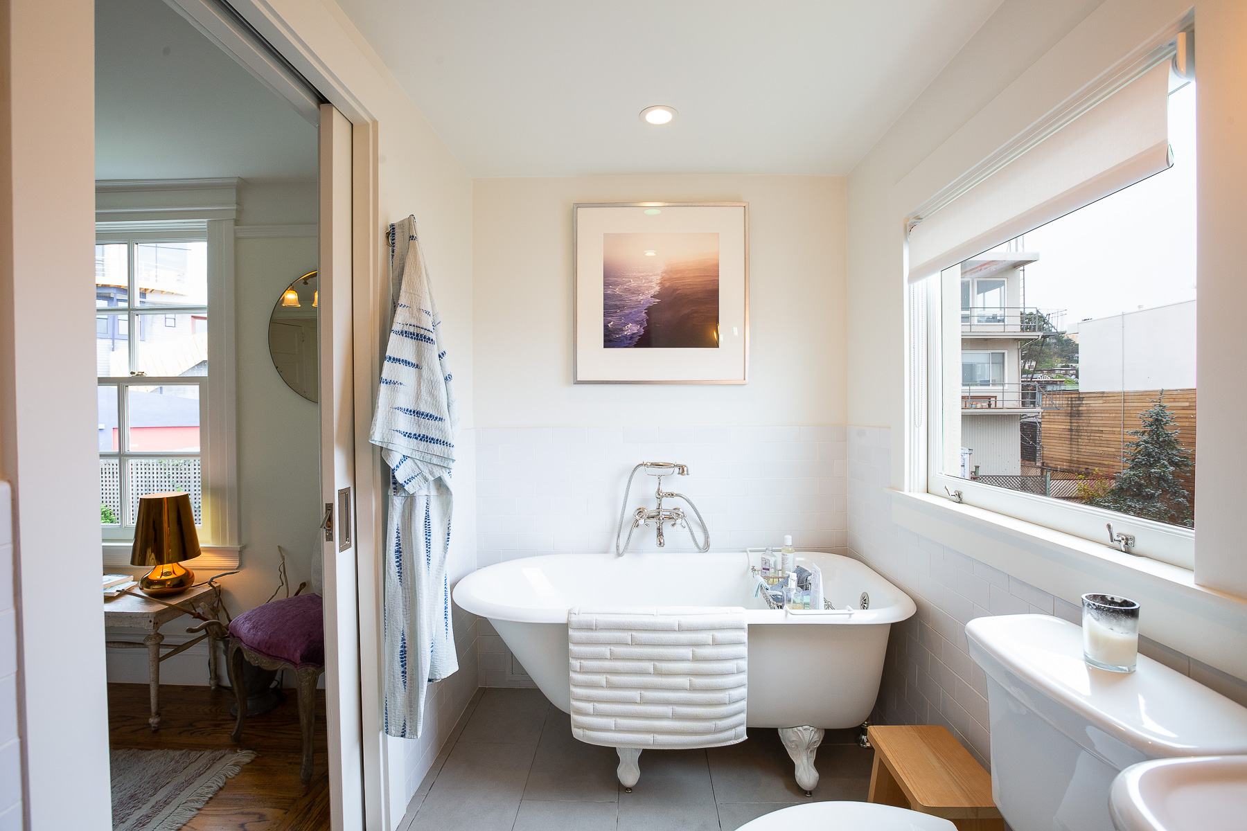 Property Photo: View of a vintage free-standing bath positioned near a large window