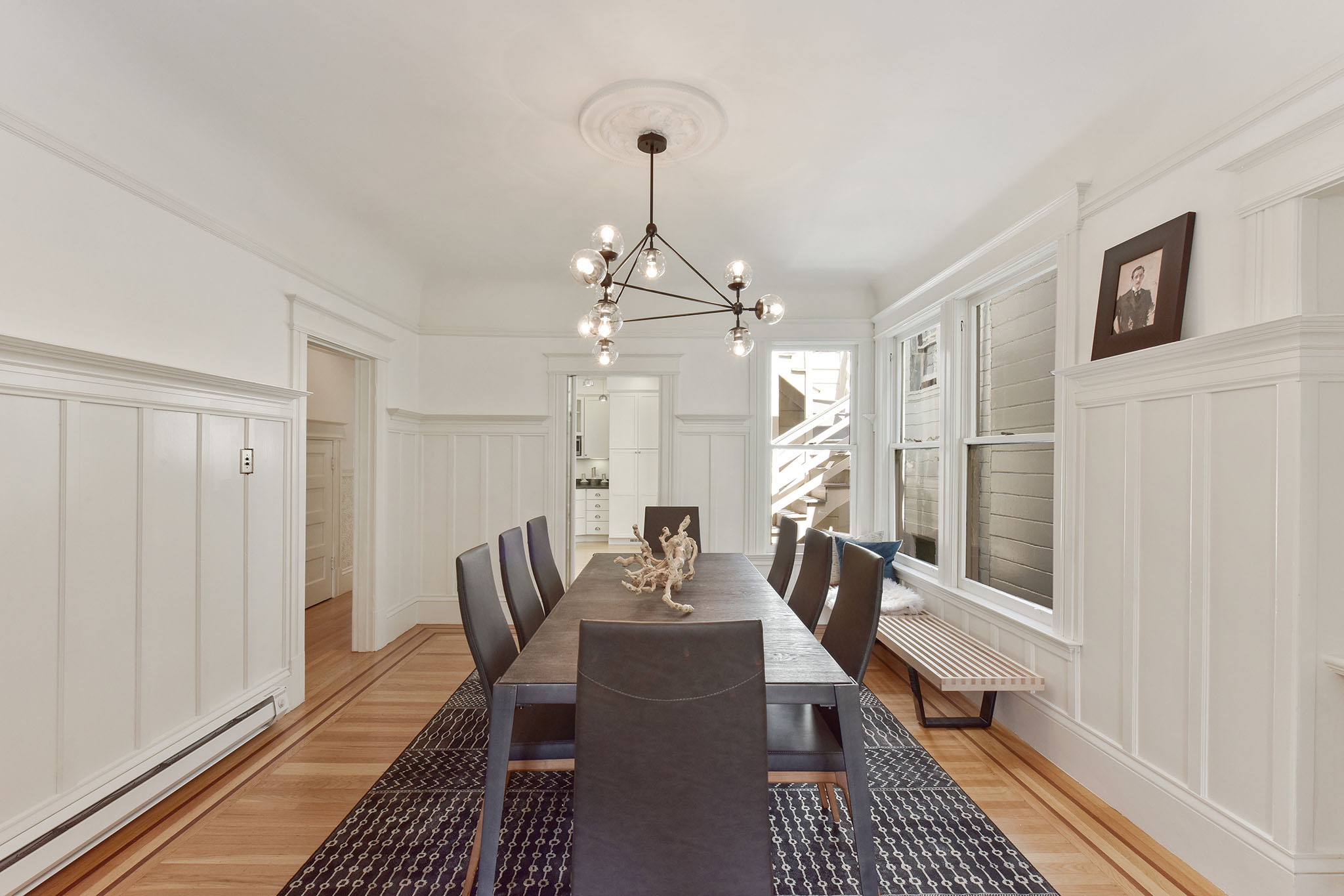 Property Photo: View of the formal dining room with white wood wainscoting
