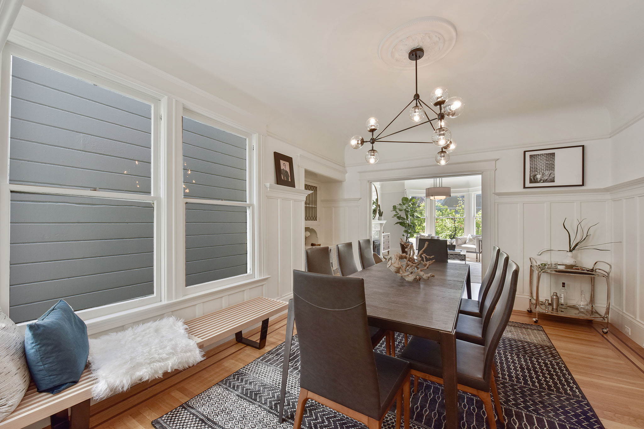 Property Photo: Dining room, featuring wood floors and large windows