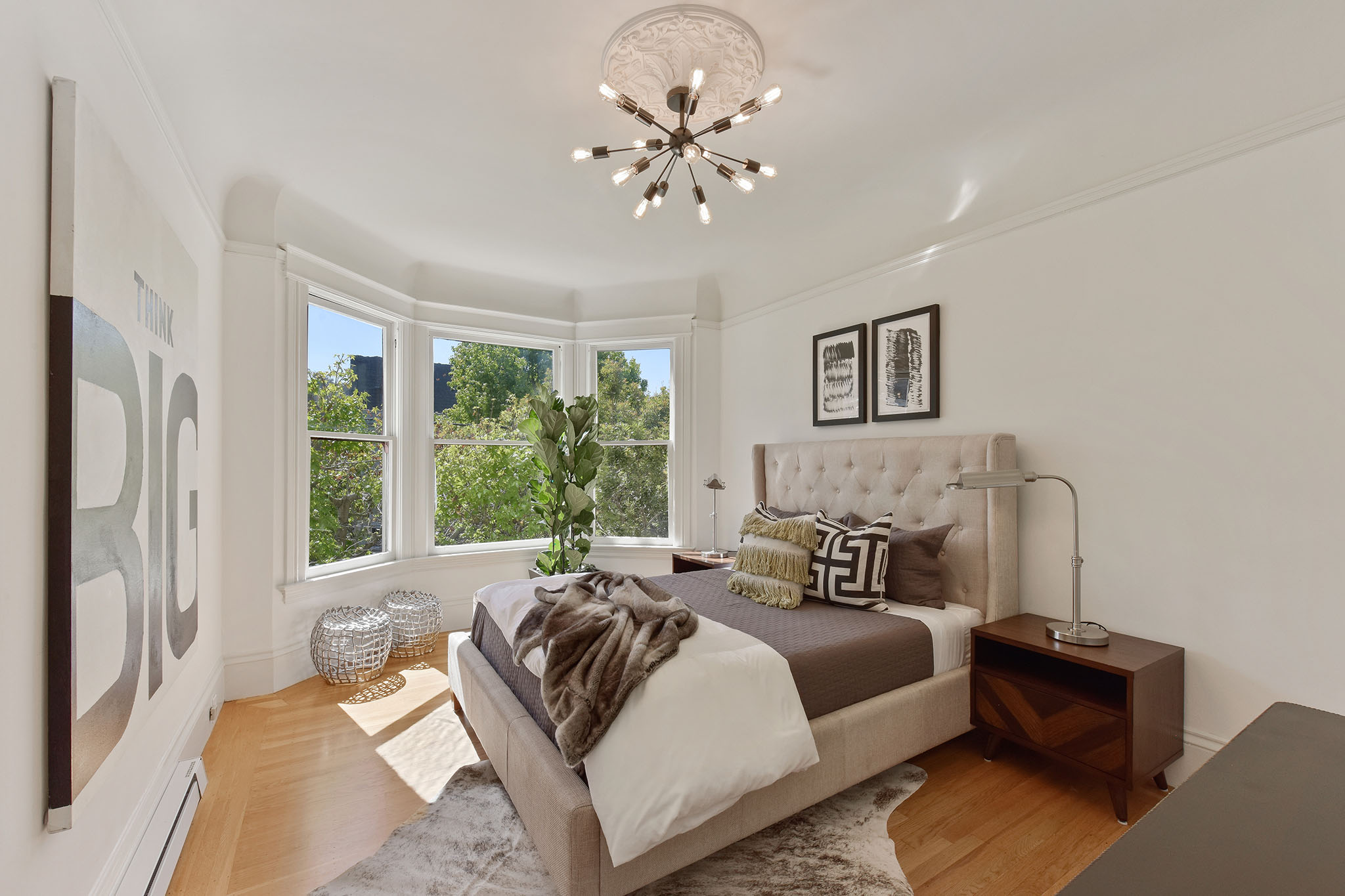 Property Photo: Bedroom, featuring wood floors and bay windows