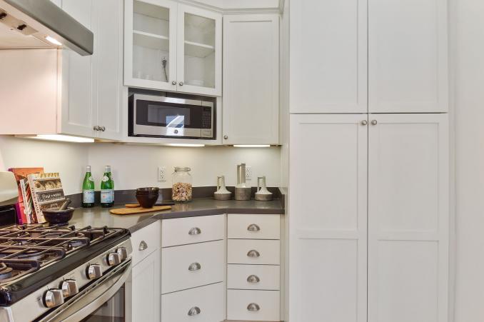 Property Thumbnail: Kitchen, featuring a stainless stove and white cabinets