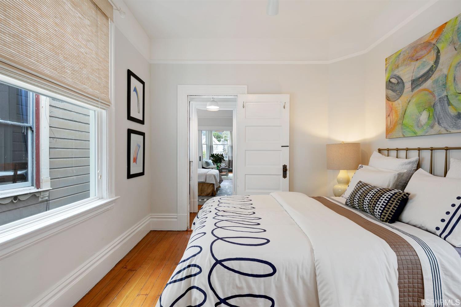 Property Photo: View of another bedroom with wood floors and crown moulding