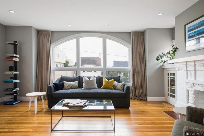 Property Thumbnail: Living room, featuring wood floors and a large arched window