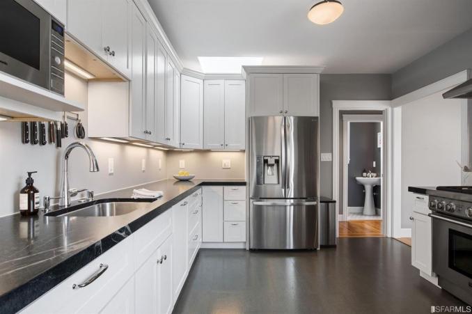 Property Thumbnail: Kitchen, featuring white cabinets with black counter-tops