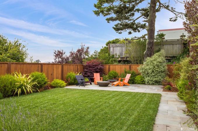 Property Thumbnail: View of the lush lawn, featuring a large grassy area and out door living space