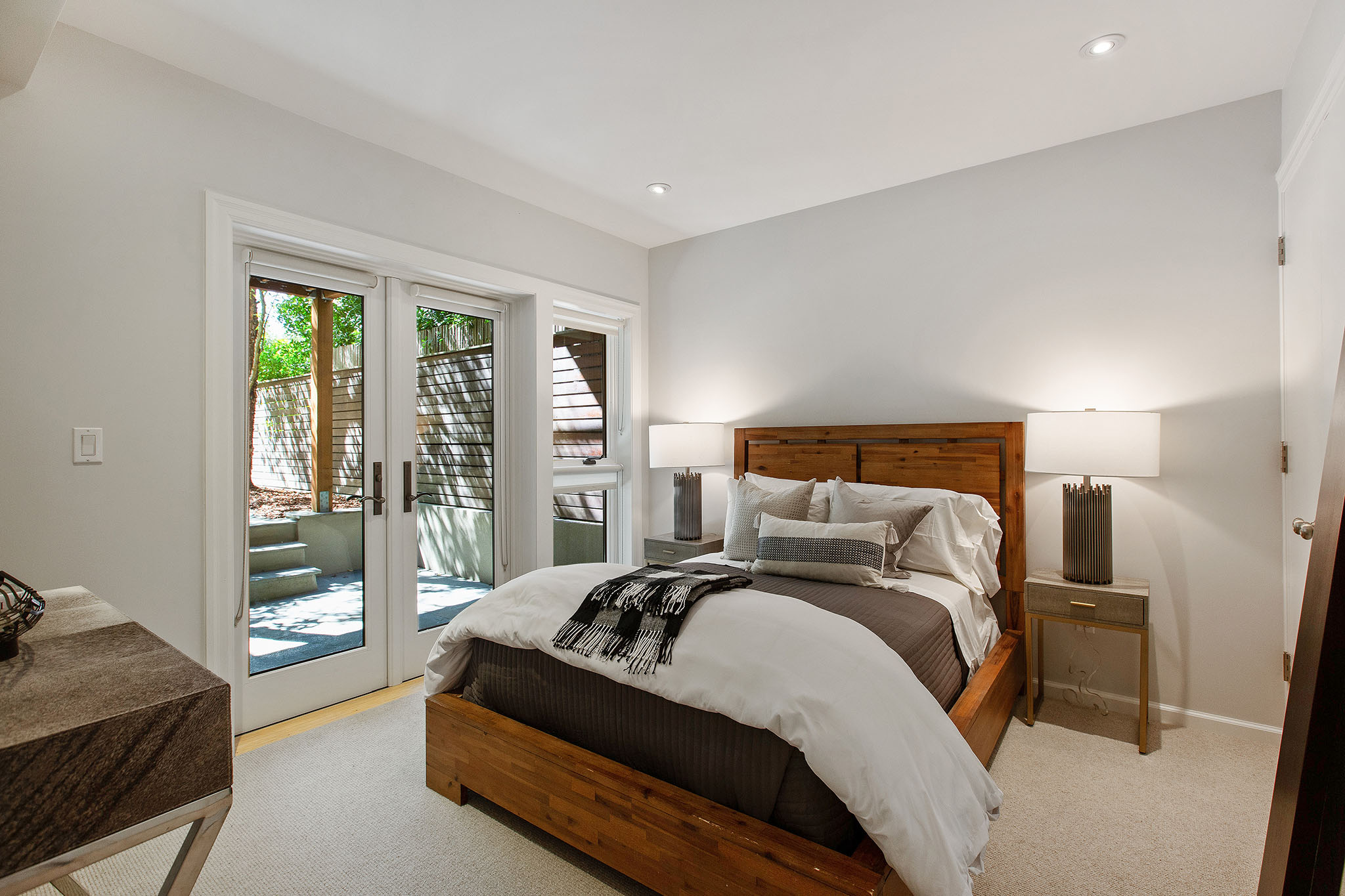 Property Photo: View of a third bedroom, with large French exterior doors
