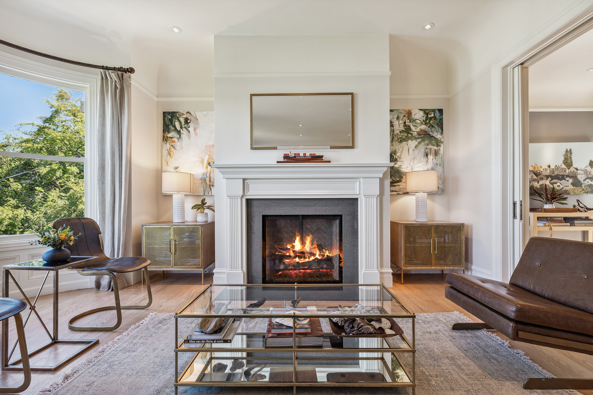 View of a fireplace with a beautiful white wood mantle, purchased via John DiDomenico