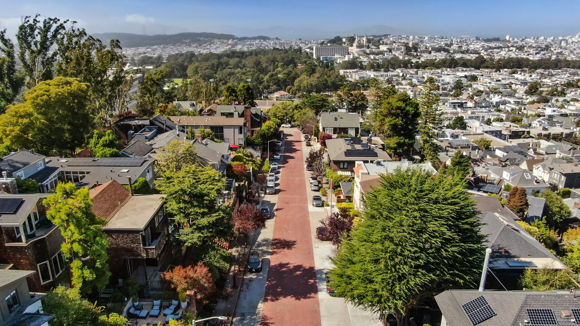 Exterior street view of 183 Edgewood Ave, showing Golden Gate Park and the San Francisco Bay in the background